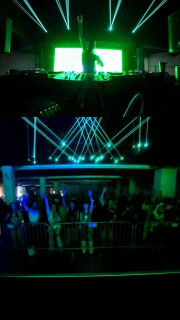 Concert stage with green lights and laser beams.